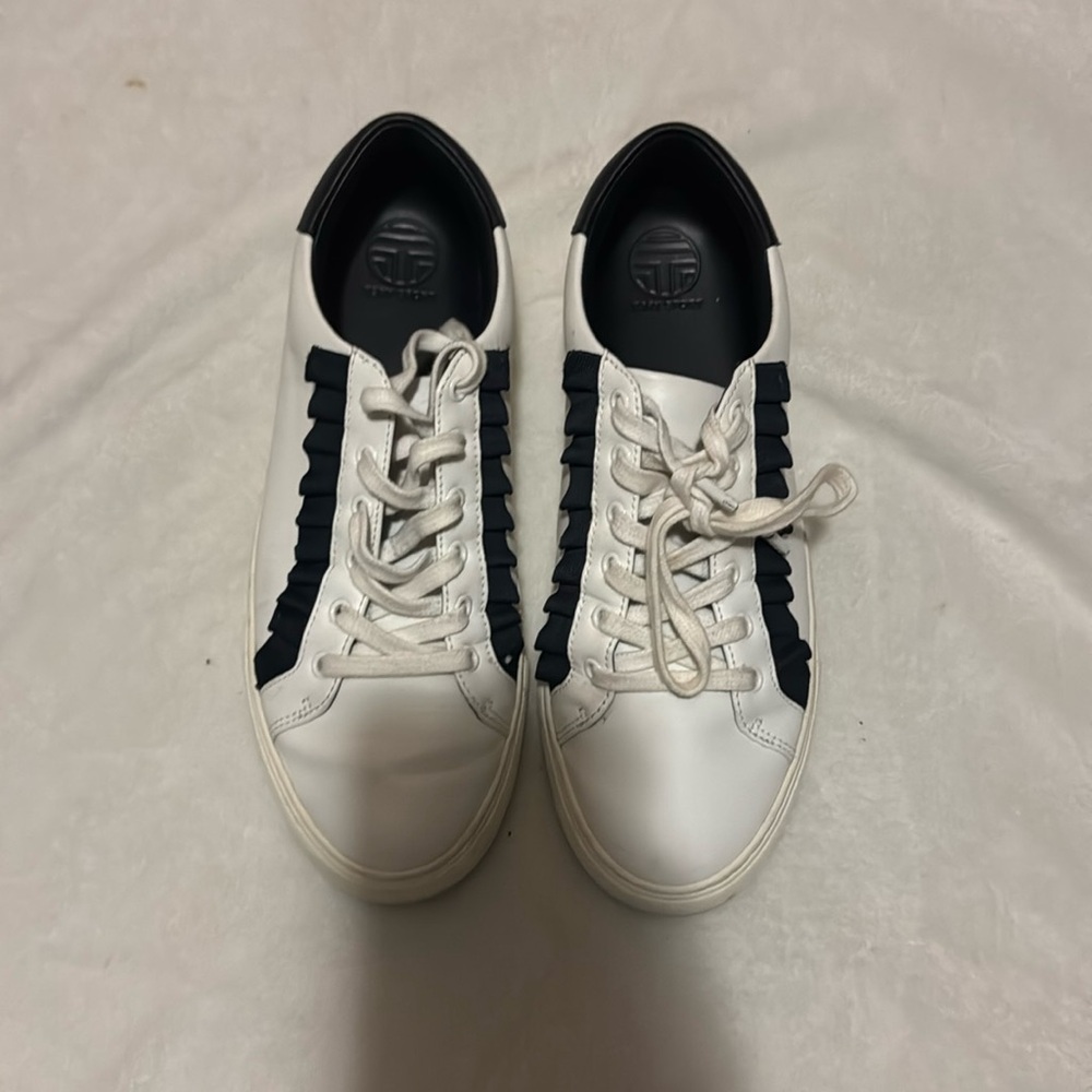 White Tory Burch tennis shoes gently worn. the ribbon is navy blue